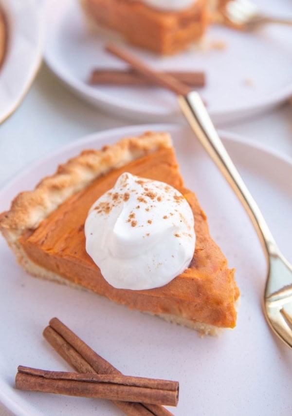 Slices of sweet potato pie on white plates