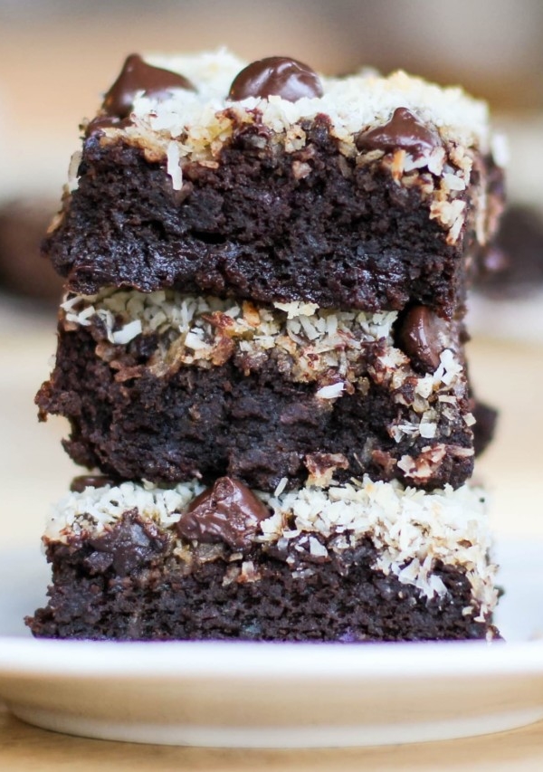 Stack of three black bean brownies on a plate, ready to eat.