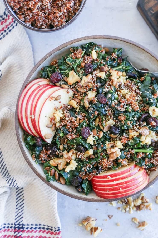 Hormone-Supporting Kale and Quinoa Salad with pumpkin seeds, apple, dried cranberries, and walnuts. This nutrient-dense salad is perfect for eating throughout the week.