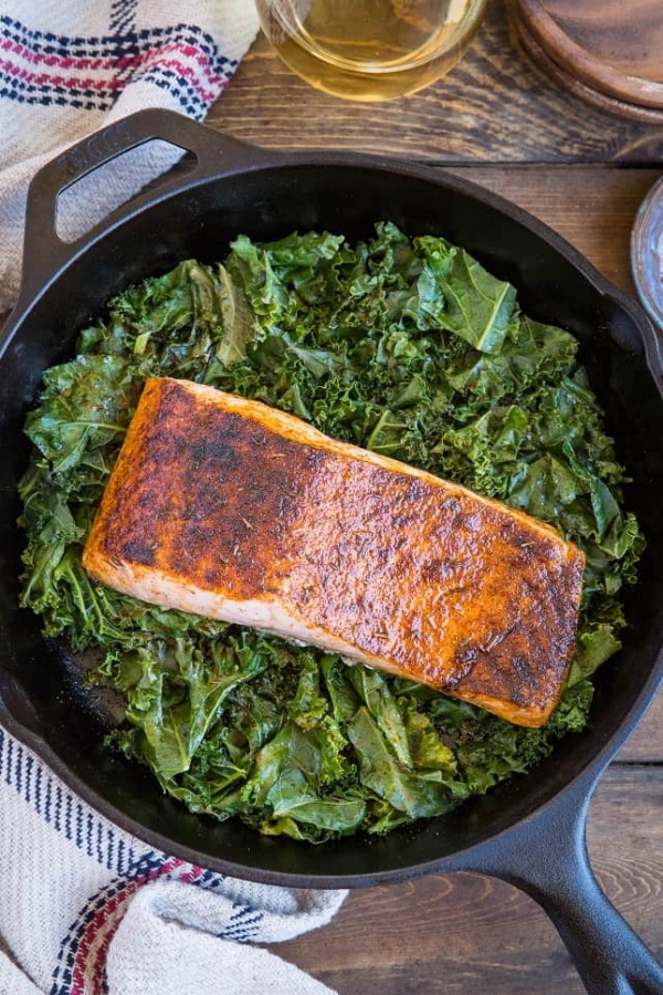 Blackened Salmon with Garlicky Cajun Kale - a healthy low-carb, keto dinner recipe from the cookbook, The Quintessential Kale Cookbook by Julia Mueller | TheRoastedRoot.net
