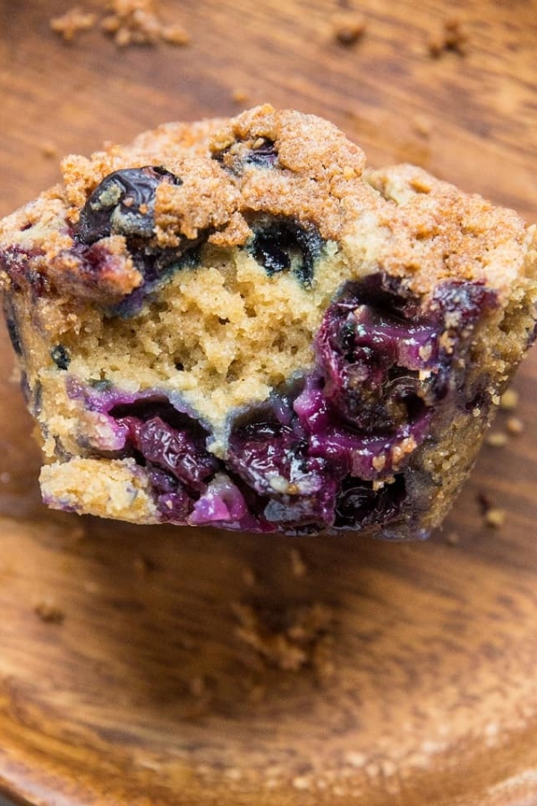 close up of blueberry sourdough muffin with bite taken out