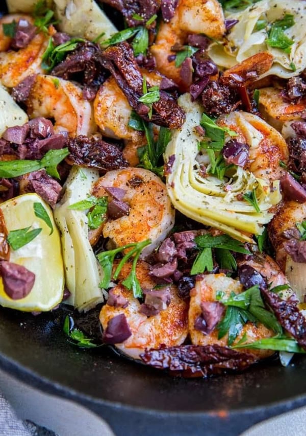 Mediterranean Shrimp with sun-dried tomatoes, artichoke hearts, kalamata olives and parsley - an easy one-skillet meal