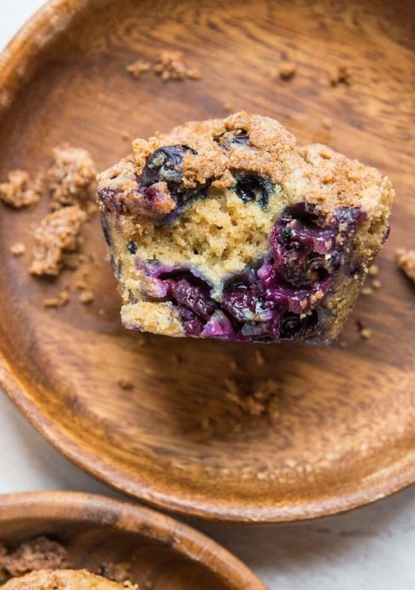 Two wooden plates with blueberry muffins on each