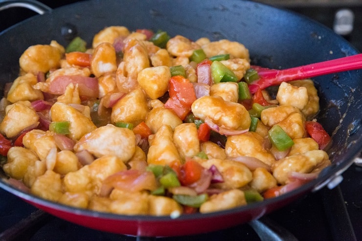 sweet and sour chicken cooking in a skillet