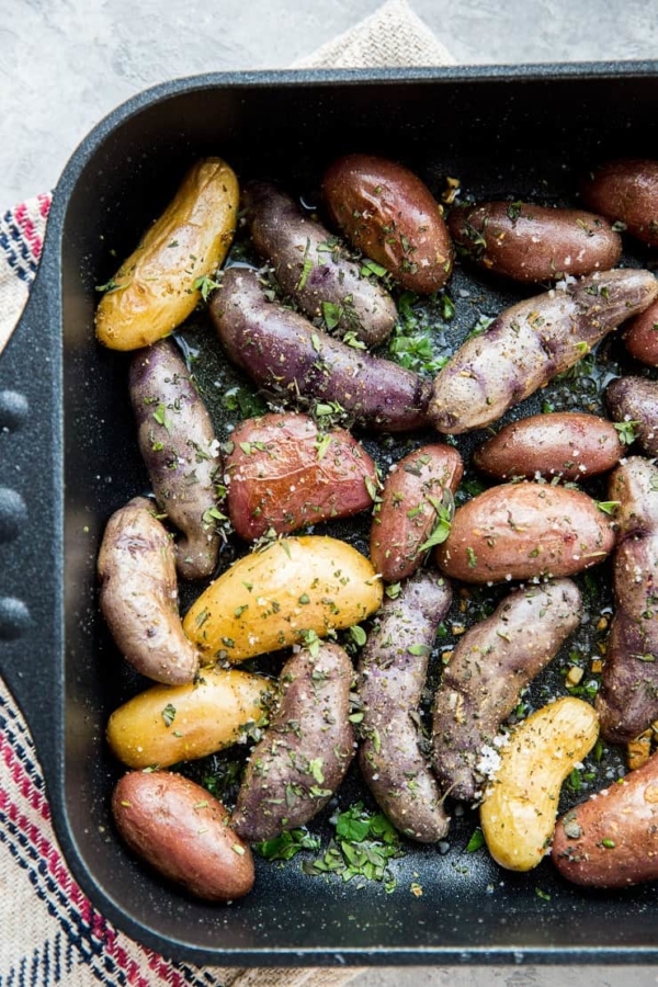 Garlic Roasted Potatoes - an easy recipe for herby garlicky fingerling potatoes with the perfect crisp. A delightful side dish to any meal!