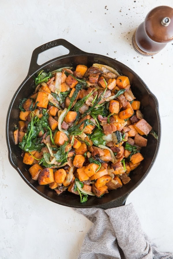 Sweet Potato Hash Recipe with bacon, onion, and spinach. This easy breakfast recipe results in perfectly crispy potatoes