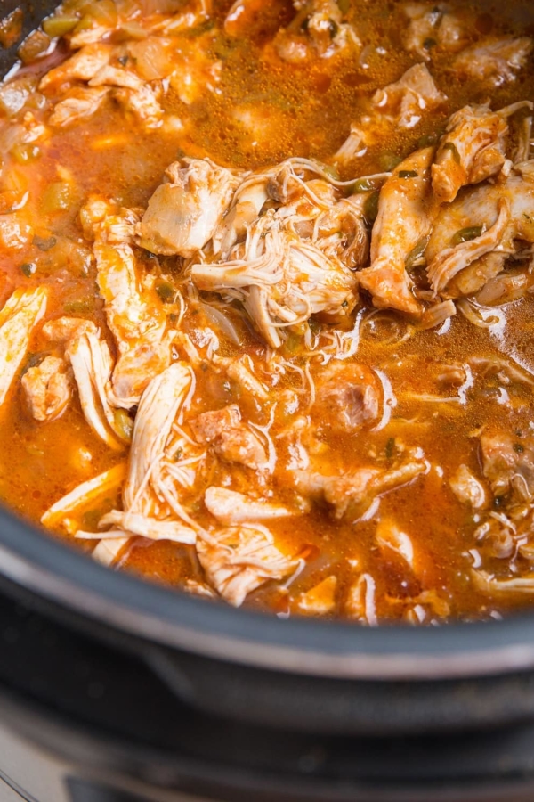 Instant Pot Mexican shredded chicken in a pressure cooker, ready to serve.