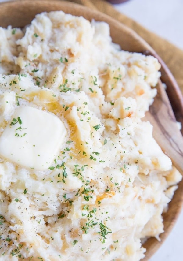 Roasted Garlic Buttermilk Mashed Potatoes with Parmesan are just brimming with flavor! The BEST Mashed Potatoes recipe right here!