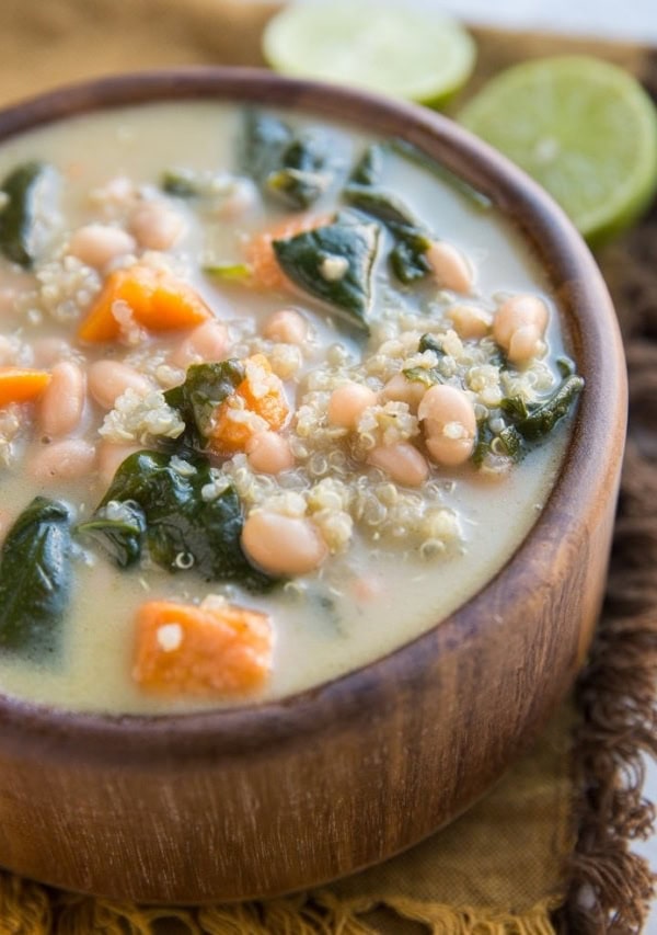 Creamy Vegan Sweet Potato and Quinoa Stew with white beans and spinach. An easy, filling meatless soup recipe