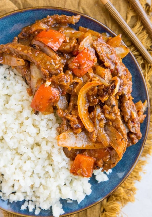 Blue plate of healthy Beijing Beef with a side of cauliflower rice