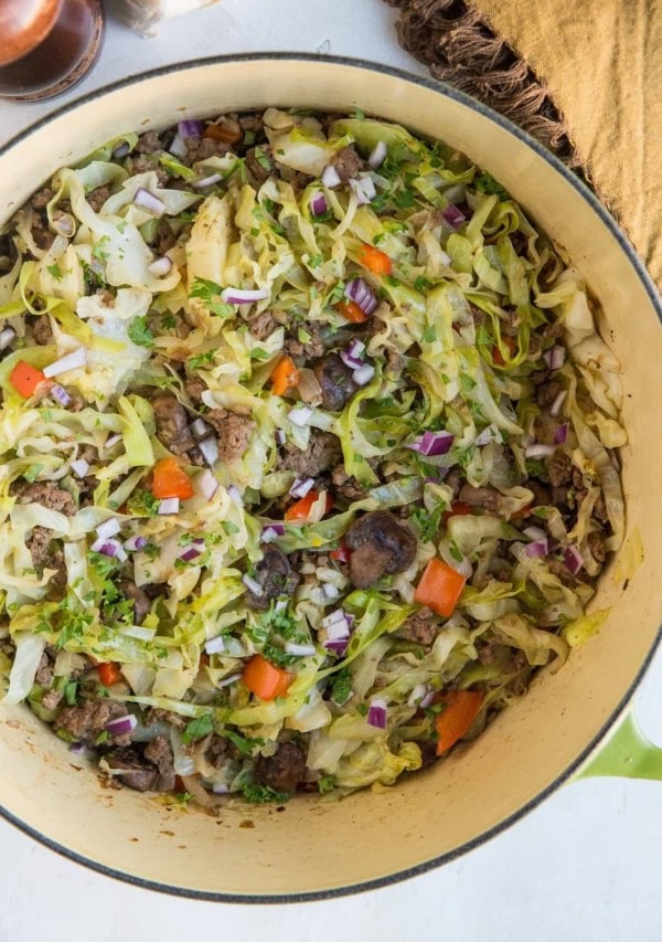 Easy One-Pot Ground Beef and Cabbage with onion, garlic, bell pepper, and mushrooms. An easy healthy low-carb dinner recipe that comes together in 30 minutes.