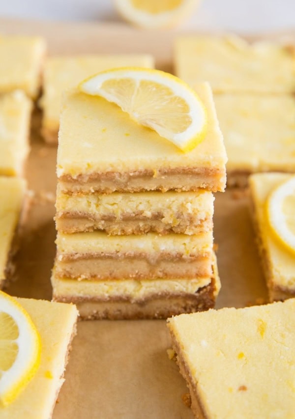 Stack of keto lemon bars with slice of lemon on top