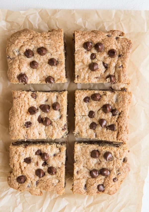 Cookie bars sliced into individual portions on a parchment paper