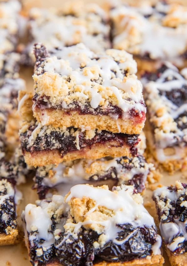 Stack of low-carb cherry pie bars on parchment paper