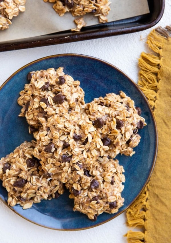 blue plate of no-bake banana cookies and a cookie tray of cookies