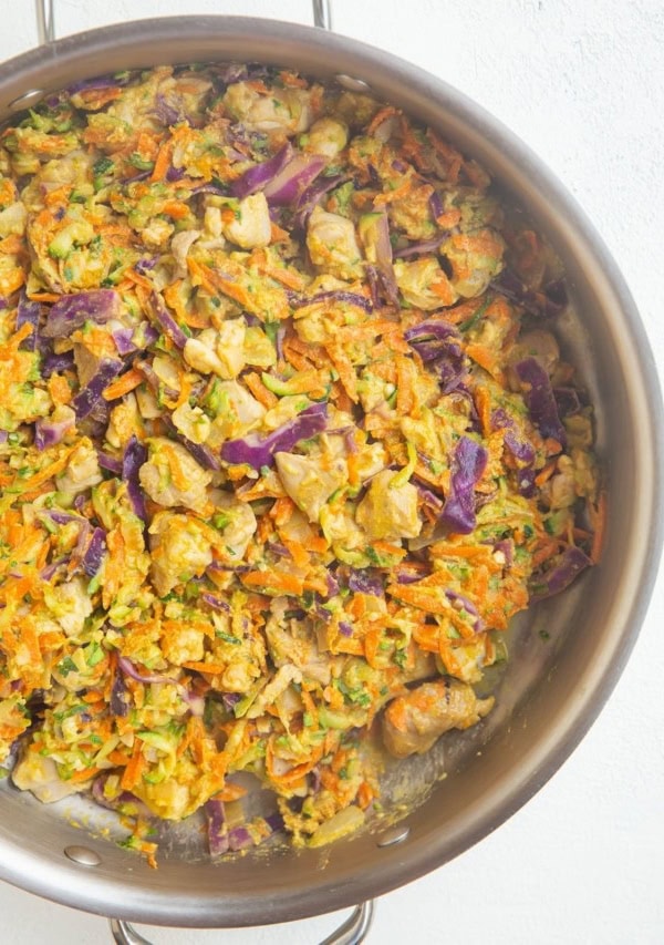 stainless steel skillet of chicken and vegetables