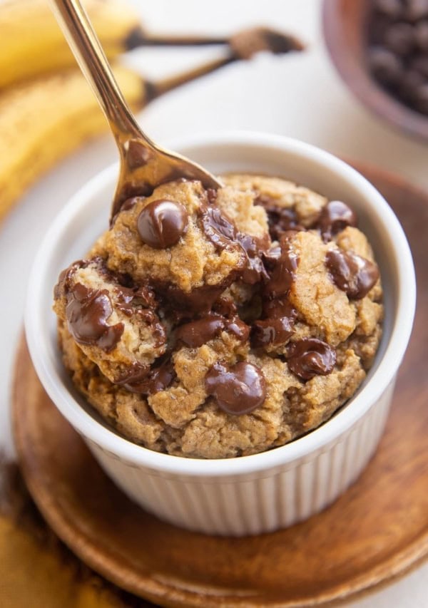 Spoon digging out banana baked oats from a ramekin.