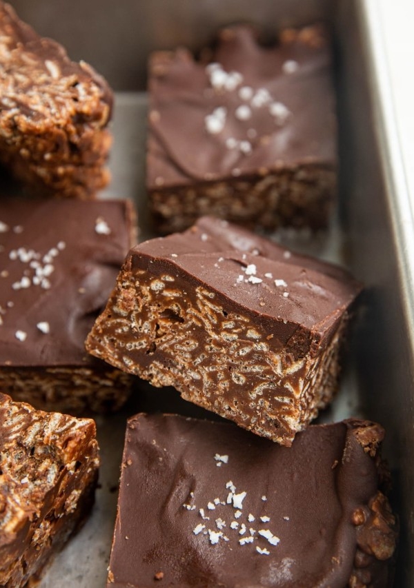 Cut bars of crispies treats in a baking dish.