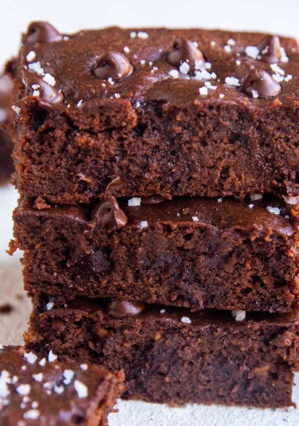 Stack of sweet potato brownies - a closeup on the brownies sprinkled with sea salt.