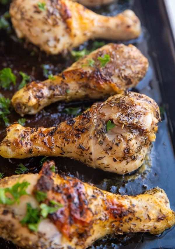 Baking sheet of honey herb chicken drumsticks fresh out of the oven.