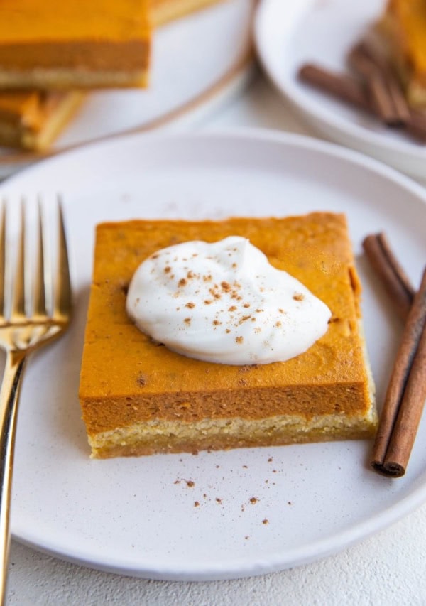 Close up shot of a slice of keto pumpkin pie on a plate, ready to be eaten