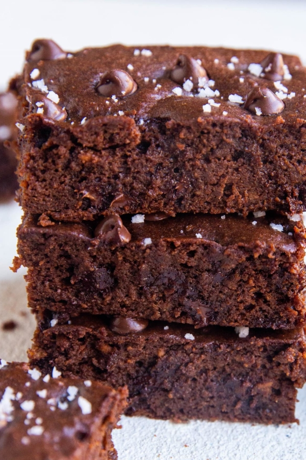Stack of sweet potato brownies - a closeup on the brownies sprinkled with sea salt.