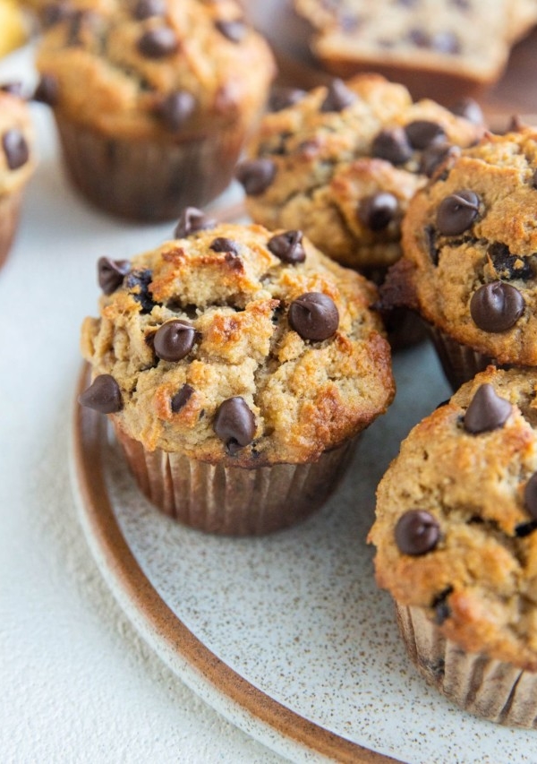 Close up angled shot of a plate of chocolate chip banana muffins