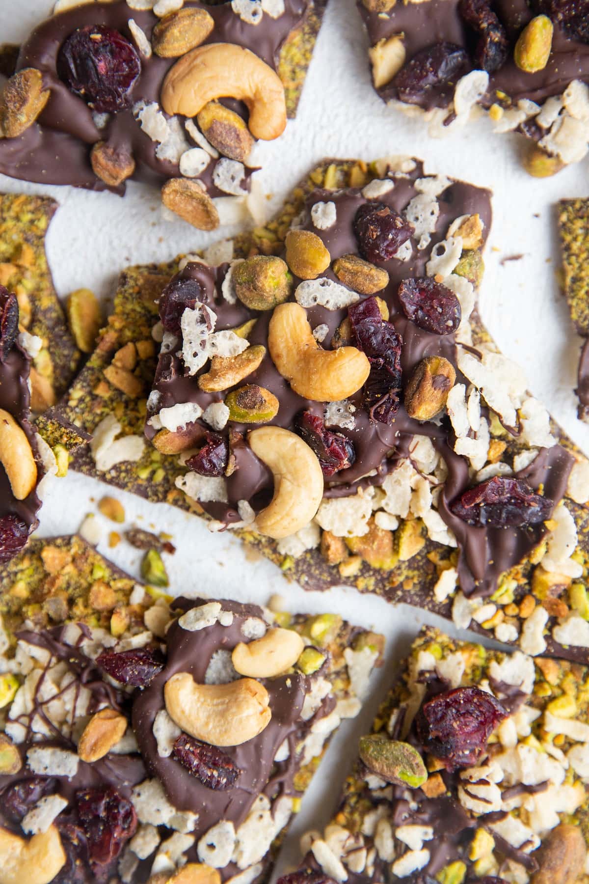 Top down photo of chocolate bark broken into chunks on a white backdrop.