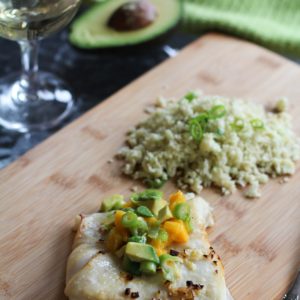 Cooked halibut with mango avocado salsa on top