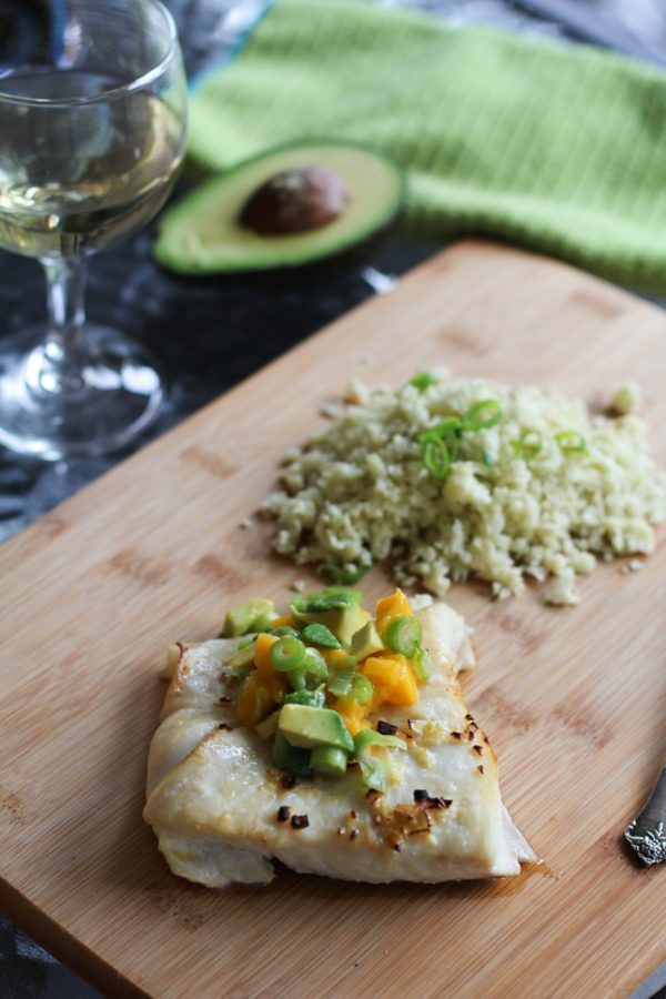 Cooked halibut with mango avocado salsa on top