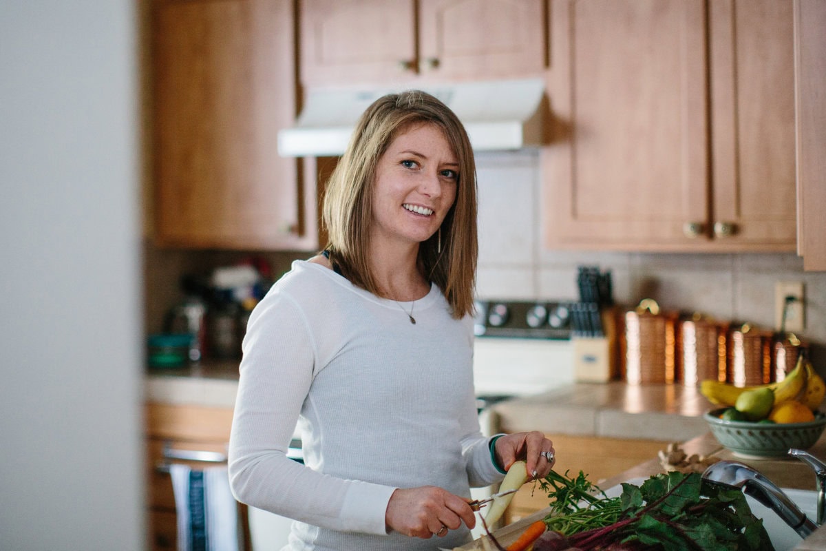 Julia Mueller peeling carrots in a kitchen