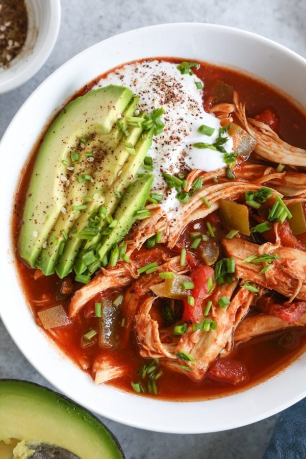 big bowl of chicken enchilada soup with avocado and sour cream