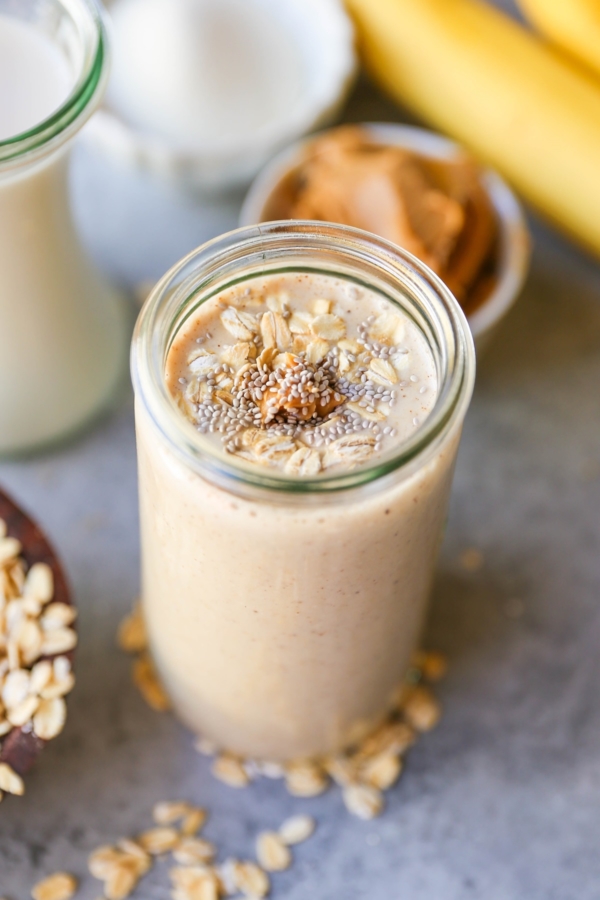 Almond Butter Protein Smoothie with chia seeds, banana, and oats in a glass, ready to drink