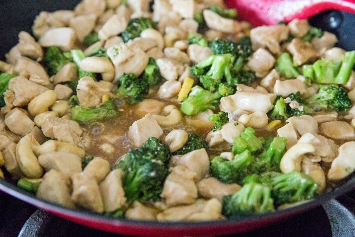 Cashew chicken cooking in a skillet