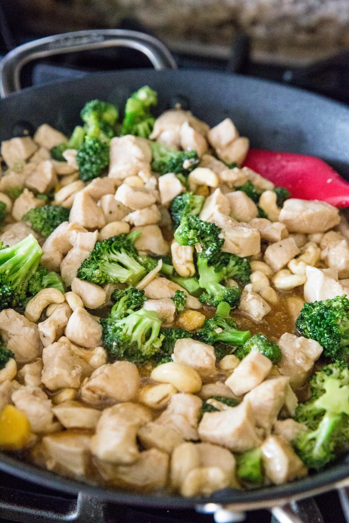 Cashew chicken cooking in a skillet