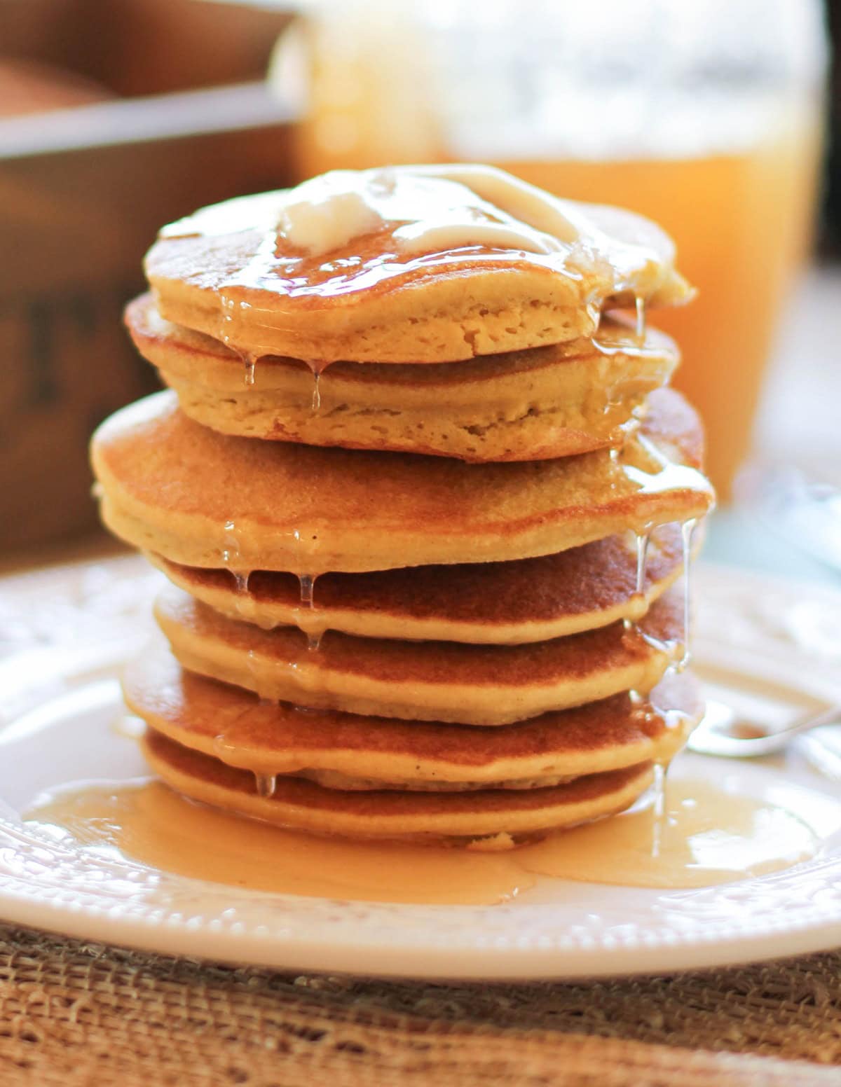 Corn Flour Pancakes on a plate with butter on top and honey dripping down. Ready to eat