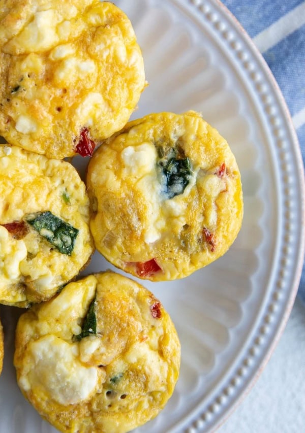 Egg muffin cups on a white plate, ready to serve.