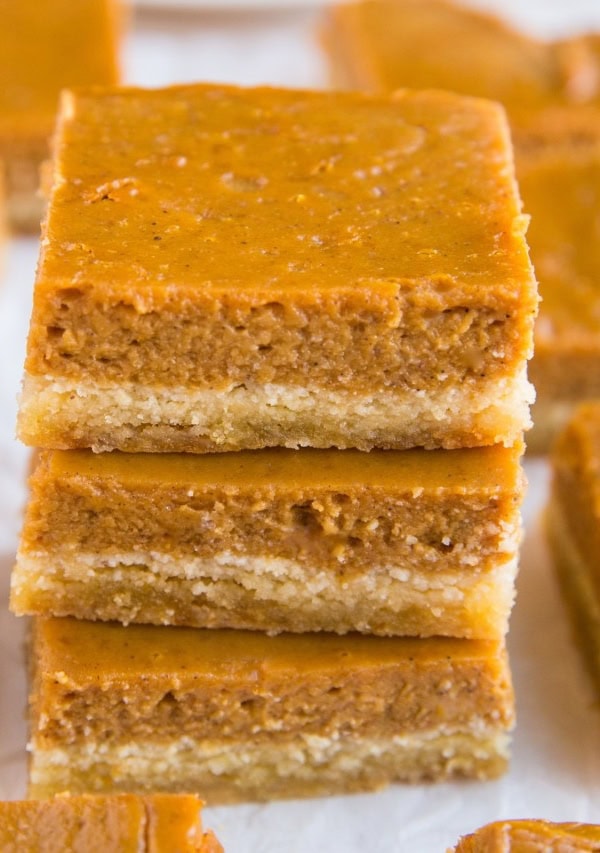 Stack of pumpkin pie bars on top of each other.