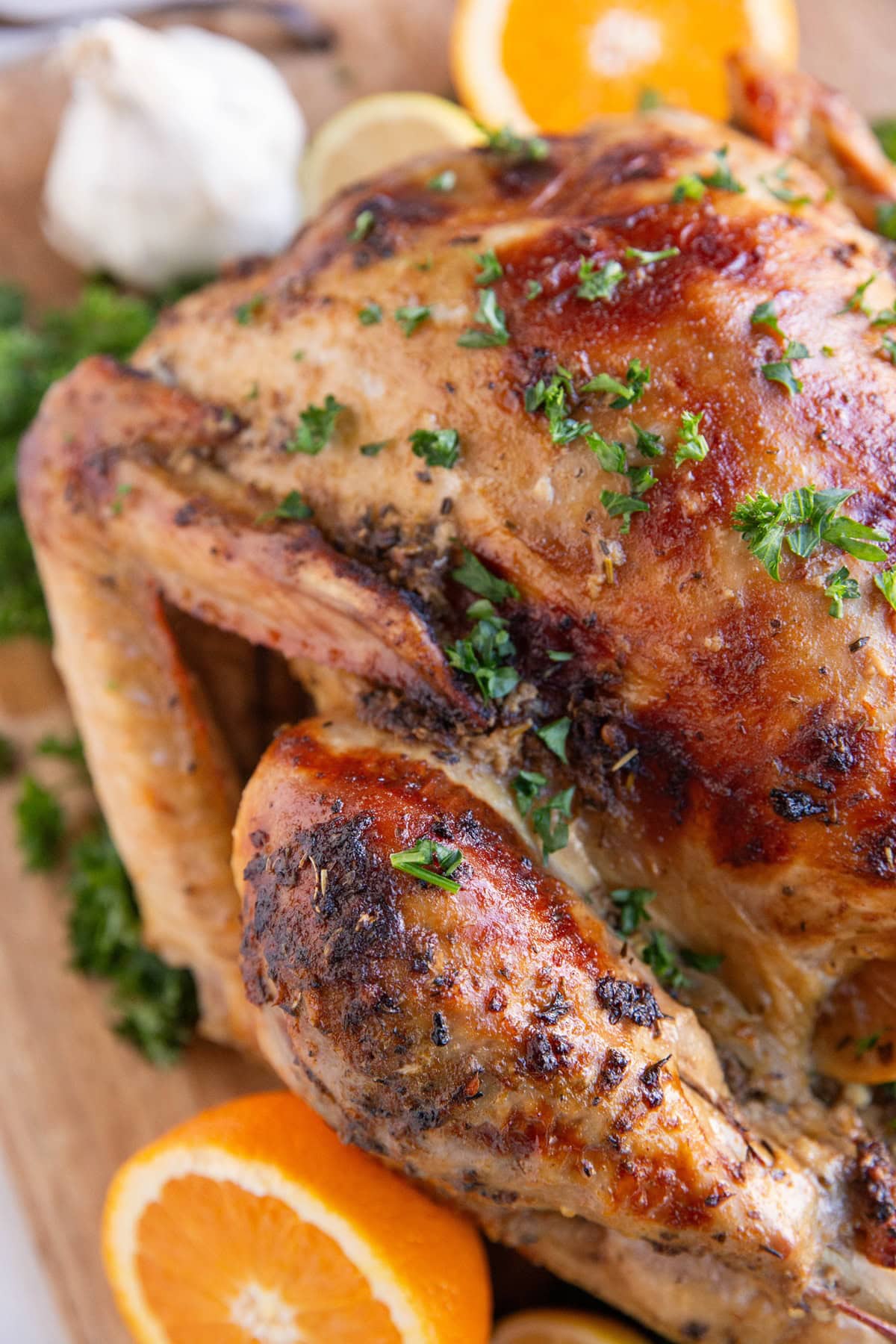 Finished turkey on a cutting board, fresh out of the oven, waiting to be sliced.