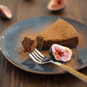 Gluten Free Chocolate Fig Cake on a blue plate with a fork taking a bite out.