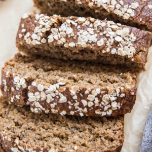 Loaf of dairy-free gluten-free oatmeal banana bread with slices cut