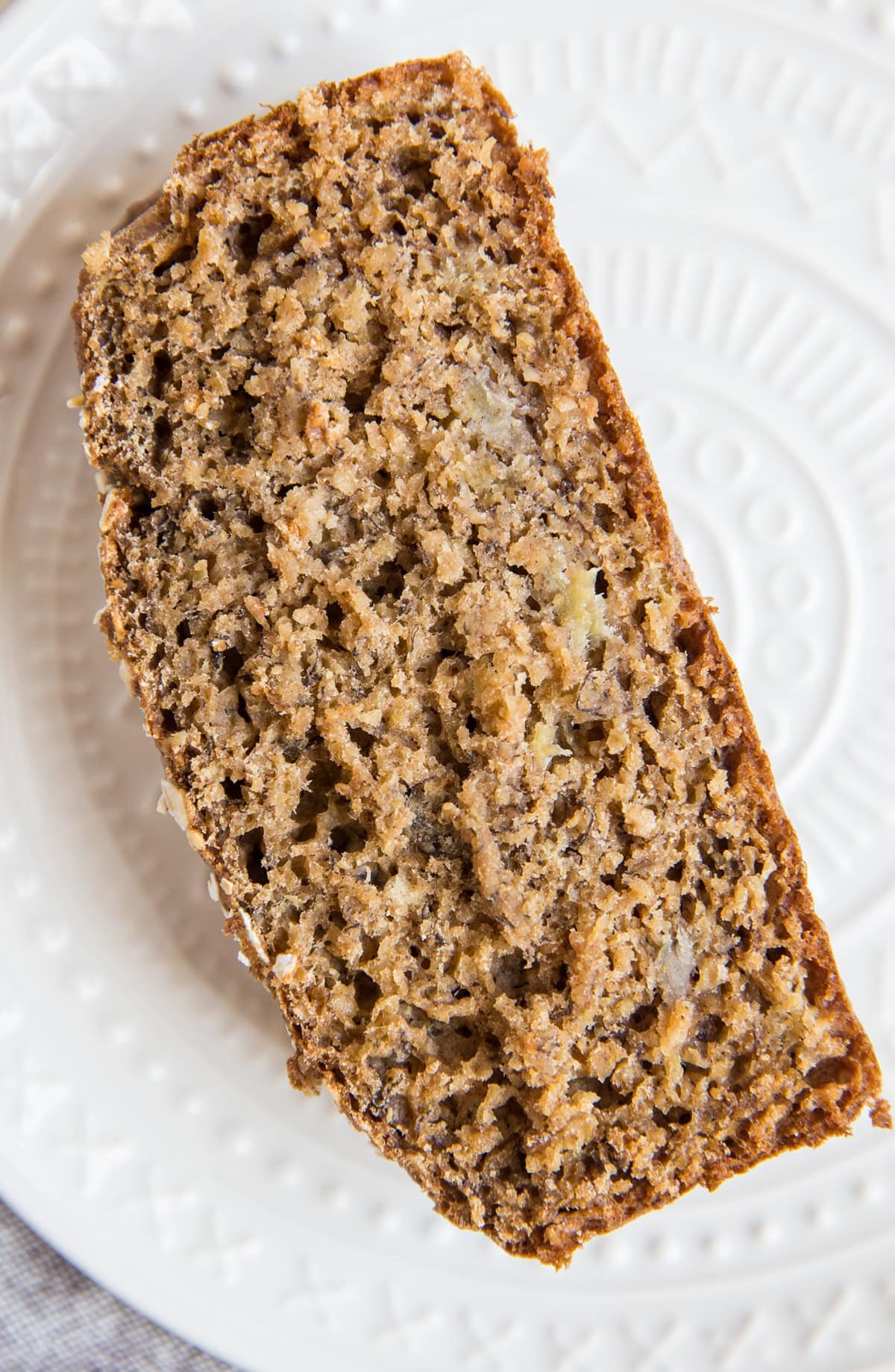 A slice of Flourless Oatmeal Banana Bread on a plate