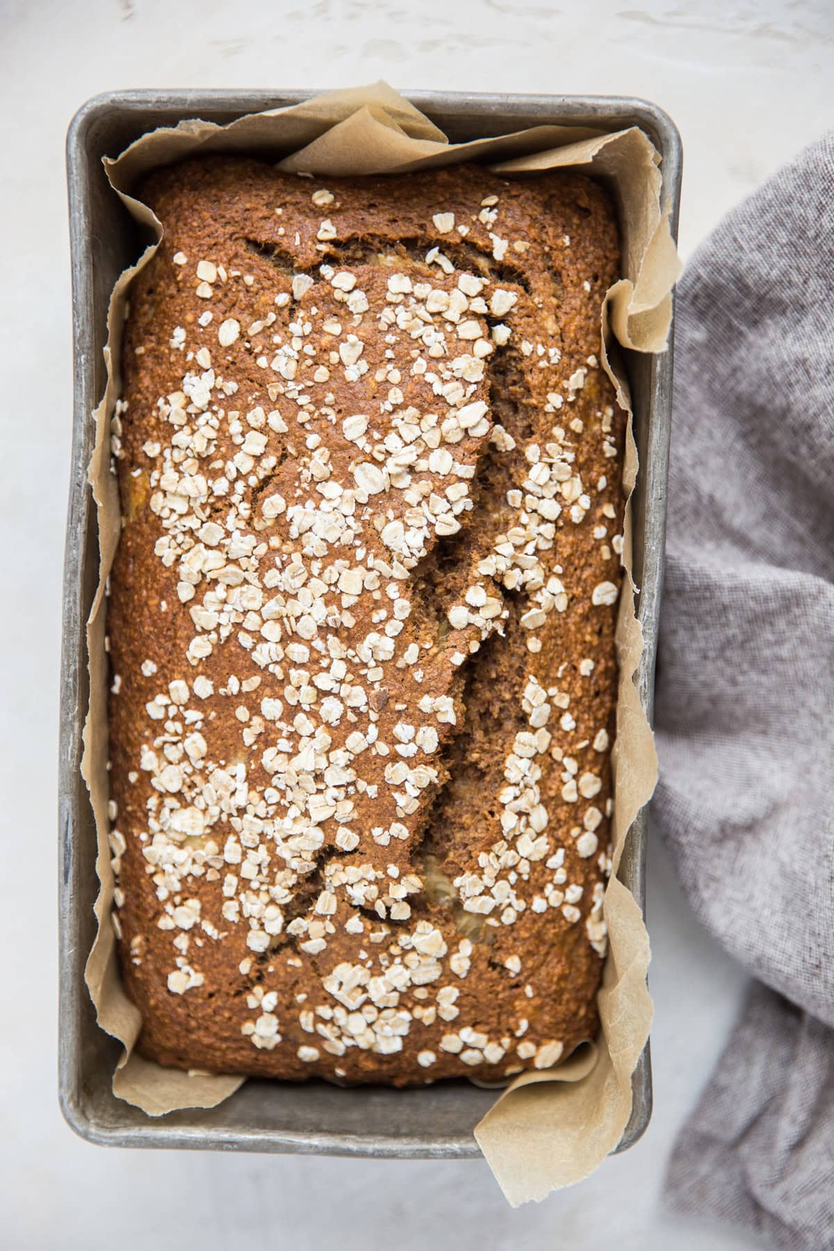 Loaf of oatmeal banana bread in a loaf pan