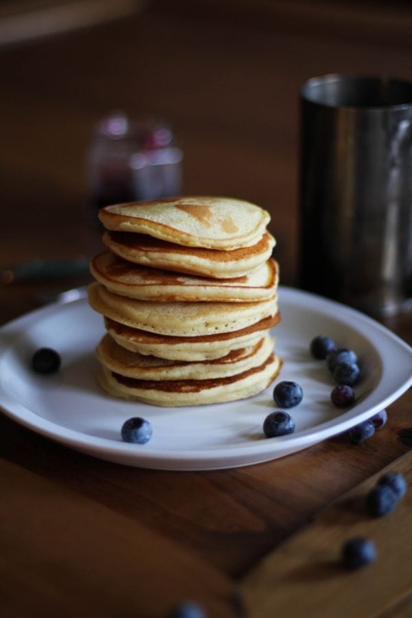 Stack of gluten-free pancakes on a plate.