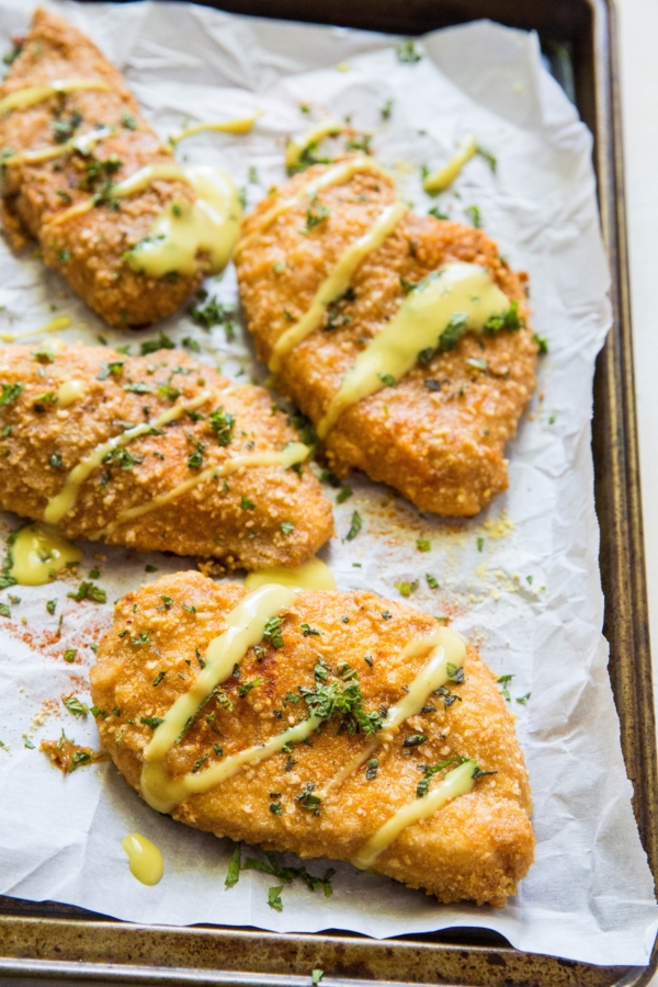 Grain-Free Pretzel-Crusted Baked Chicken - a healthier take on crispy chicken on a baking sheet fresh out of the oven.