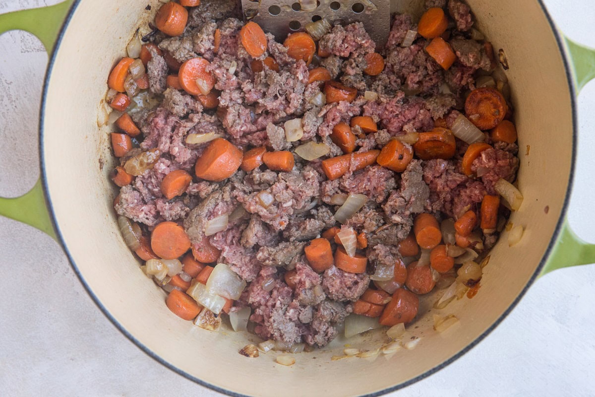 Brown the beef and stir it into the vegetables