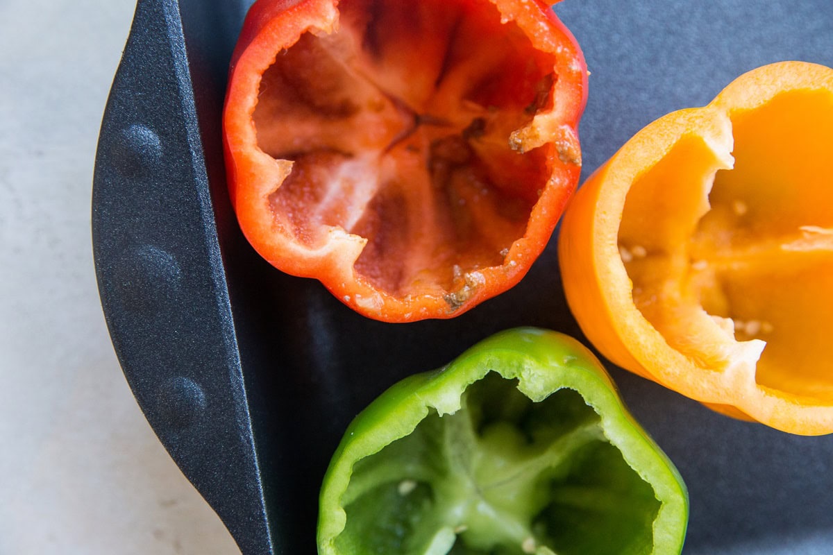 Empty bell peppers in a baking dish, ready to be stuffed.