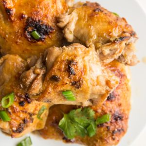 White plate full of cooked jerk chicken