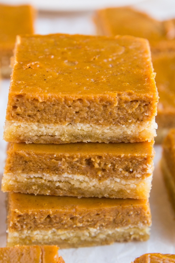 Stack of pumpkin pie bars on top of each other.