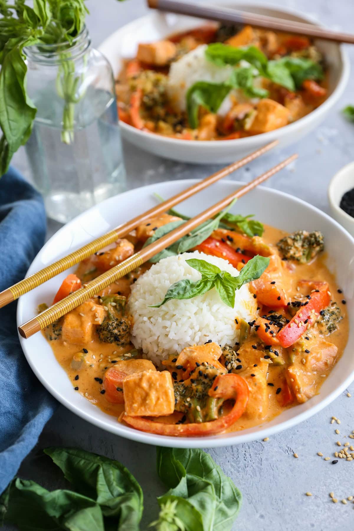 Salmon Red Thai Curry with Vegetables in white bowls with white rice, ready to serve.